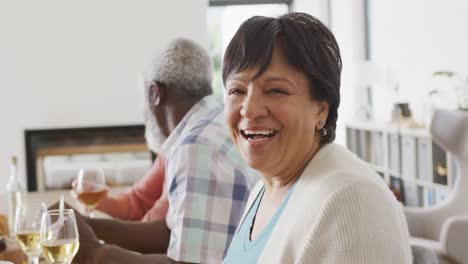 Portrait-of-happy-senior-diverse-people-having-dinner-at-retirement-home