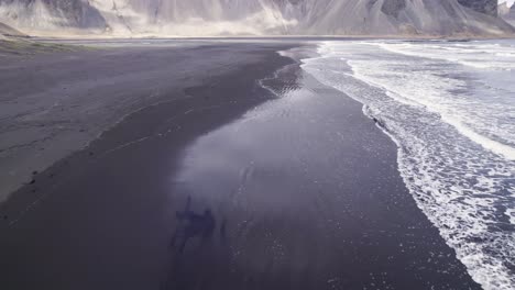 Sea-waving-near-mountain-ridge