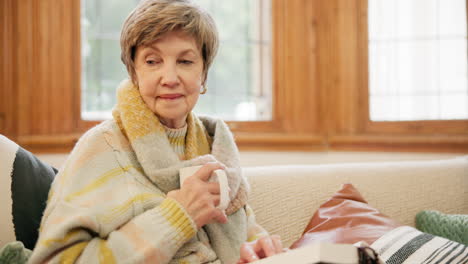 Coffee,-bible-and-senior-woman-on-sofa-in-home