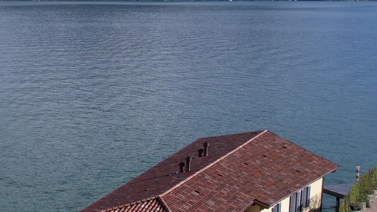 Dramatic aerial view of the serene Italian Alps by a tranquil lake