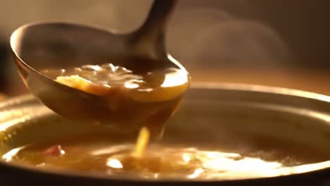 pouring soup with ladle