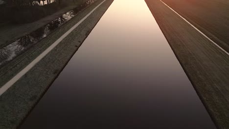 sunrise over a canal in the dutch countryside