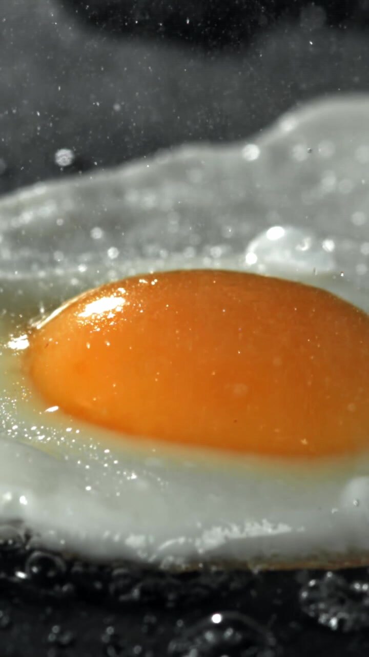 Macro Shot of a Fried Egg Sizzling in a Hot Pan