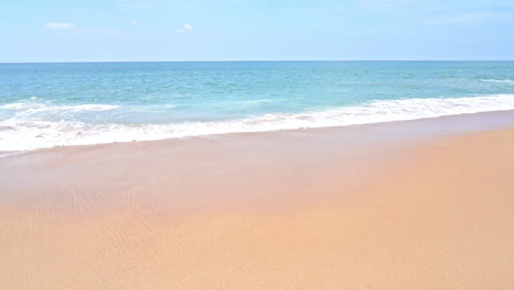 Sea-waves-with-foam-rolling-and-splashing-over-orange-color-sandy-empty-beach,-Tropical-vacation-backgrounds,-template-copy-space-no-people