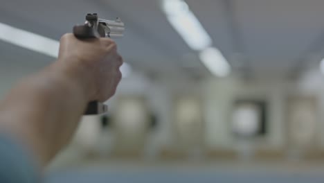 POV-of-revolver-being-aimed-on-shooting-range-and-fired