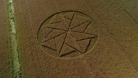 extraterrestrial farmland crop circle geometry artwork stanton st bernard aerial view wiltshire tilt down drone shot