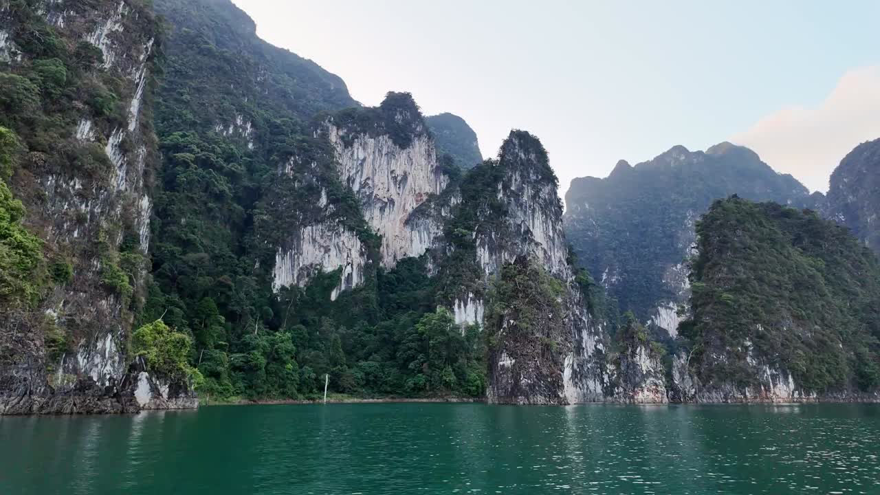 Panning Shot of Vegetated Cliffs Overlooking Turquoise Ocean, Thailand
