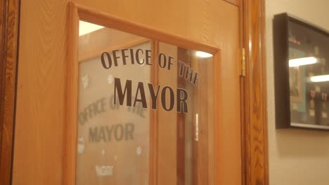 office of the mayor sign on a glass design of a door