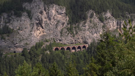 Beautiful-train-tunnel-at-Semmering-Railway-in-rocky-cliffs-with-passing-shadows