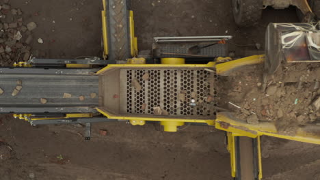 aerial top down view of construction waste sorter machine on cloudy day