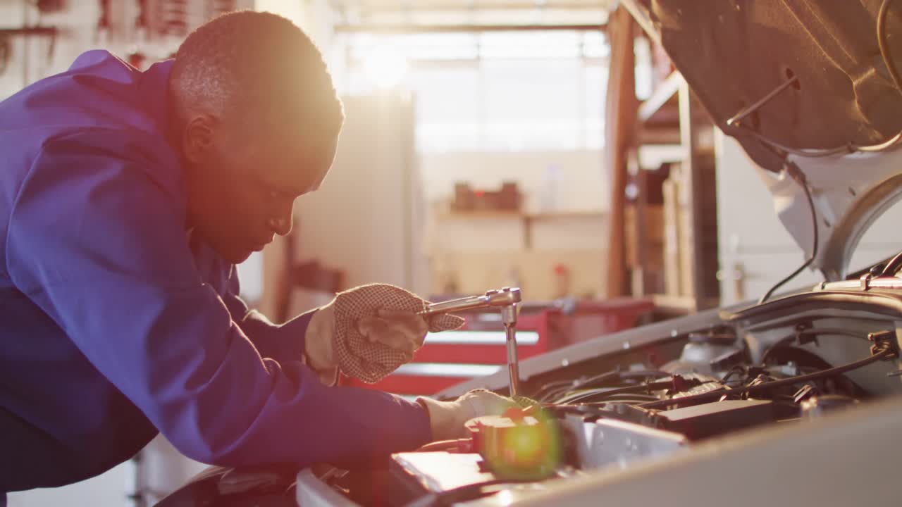 Video of african american female car mechanic repairing car