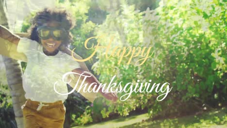 Animation-of-happy-thanksgiving-over-happy-african-american-boy-in-superhero-costume
