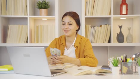 happy female student earning money.