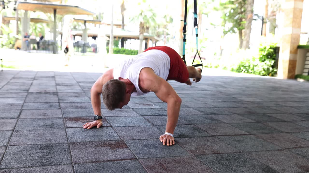 Man exercising with suspension training system