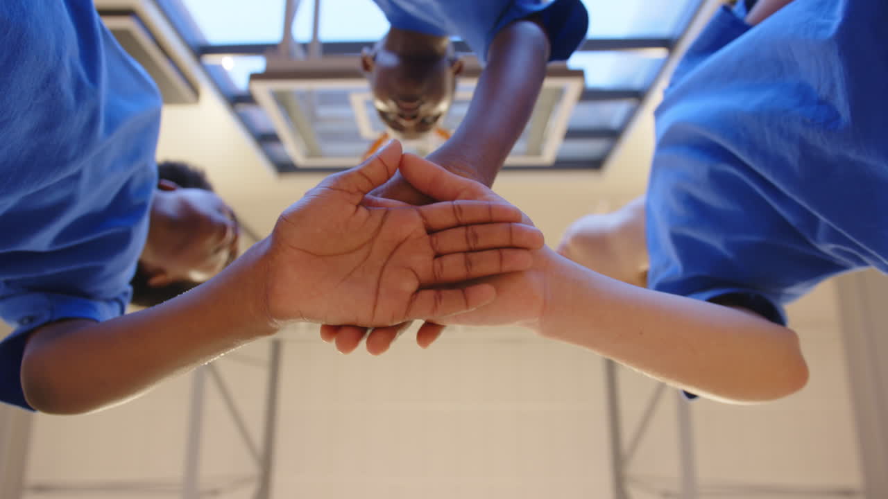 Students in school gym huddling together, showing teamwork and unity