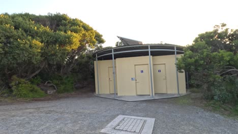 toilet block surrounded by trees and pathway