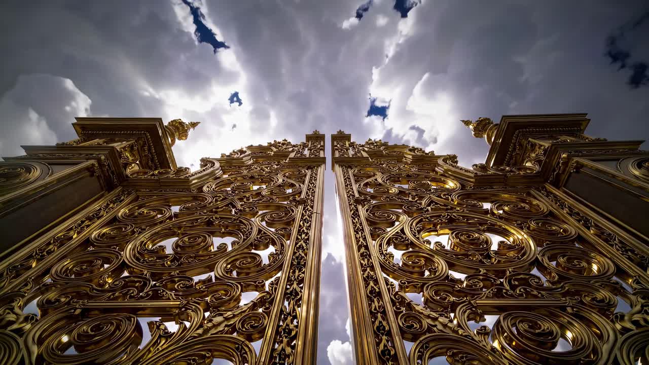 A video still of ornate golden gates opening towards a bright sky, viewed from a low angle