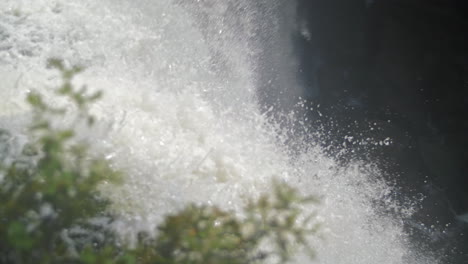 water rushing over the edge of a waterfall in slow motion