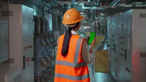 engineer using smartphone in industrial setting