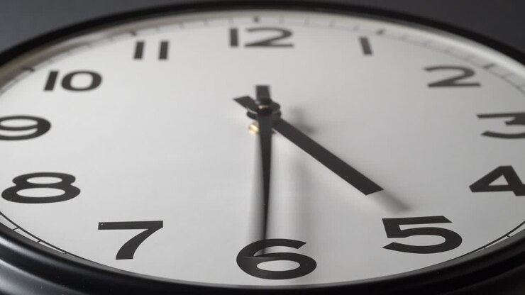 Clock Face Changed Focus on dark grey background in time lapse