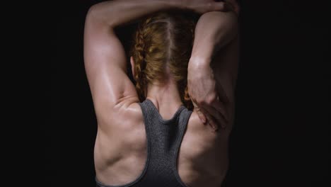 woman stretching her back muscles during a workout