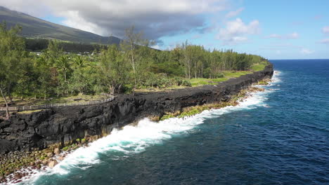 Aerial-view-over-the-Lava-rock-formation-of-Cap-Mechant-and-the-coastline-of-Reunion-Island