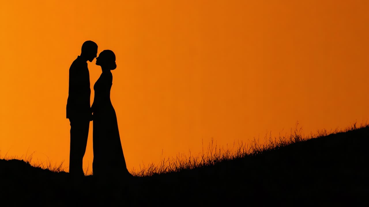 A Romantic Silhouette of a Couple Embraced in a Tender Moment at Sunset, Capturing the Essence of Love and Connection Against a Vivid Orange Sky