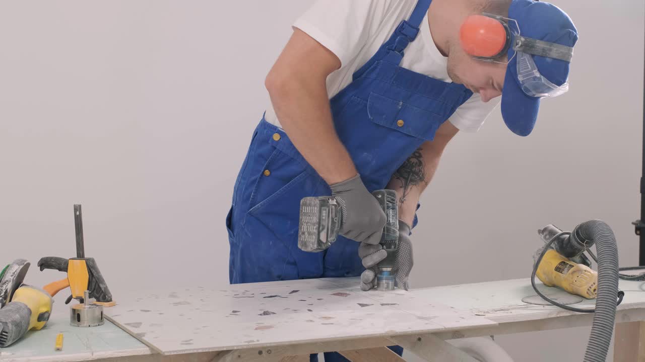 Installing ceramic wall tiles - measuring and cutting the pieces. Construction, renovation, repair apartment. Cuts tile. Tile cutting