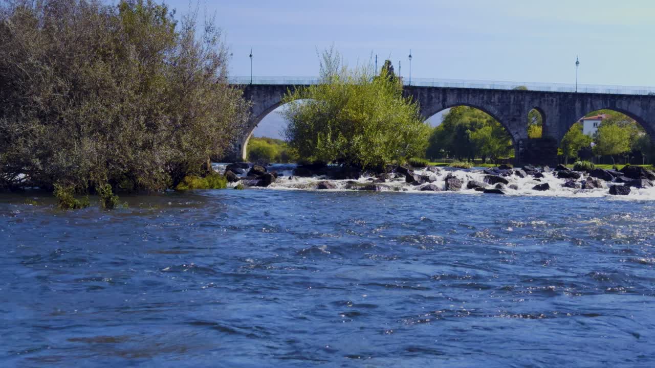 Ponte da Barca and the old Roman bridge over the Lima river, view over the rapids