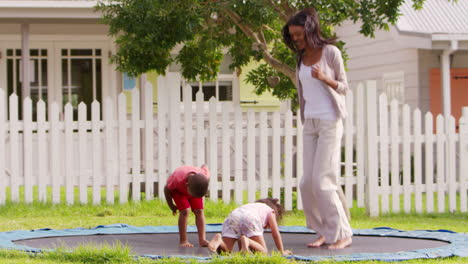 teacher at montessori school playing with pupils on trampoline