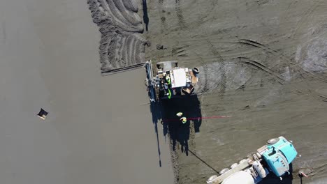 A-top-down-shot-of-a-screed-machine-smoothing-concrete