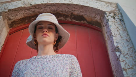 girl exploring old town on summer vacation. closeup casual model posing at door