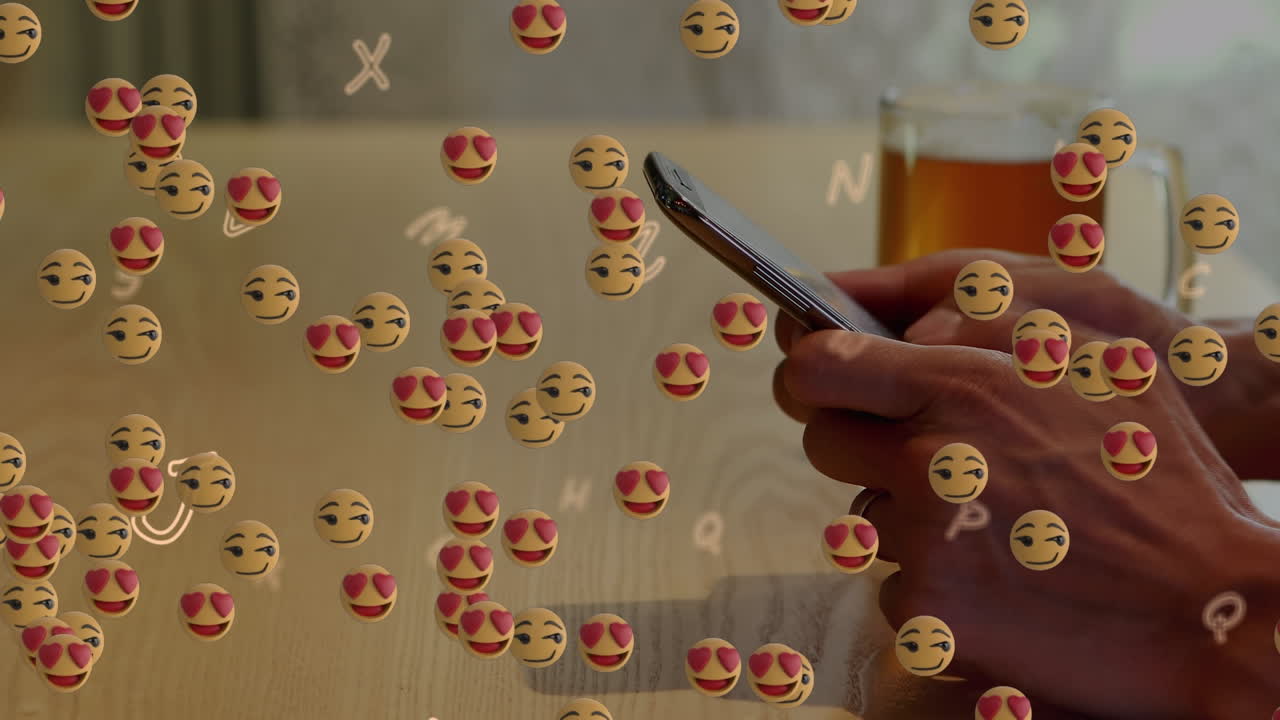 animación de emojis flotantes sobre la mano usando un teléfono inteligente