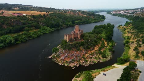 drone orbit circles almourol castle on tagus river and surrounding landscape