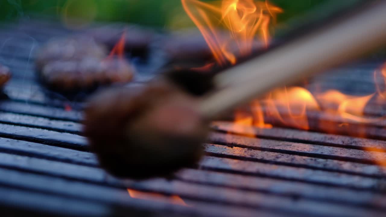 Cooked meatballs are taken and turned with tongs slow motion close up