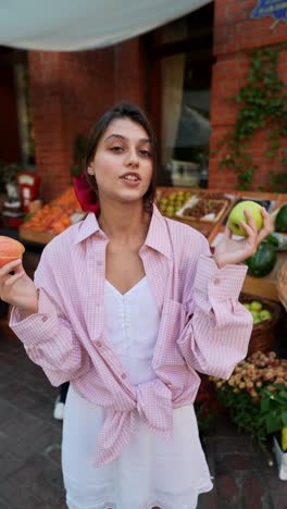 woman buying apples at a street market