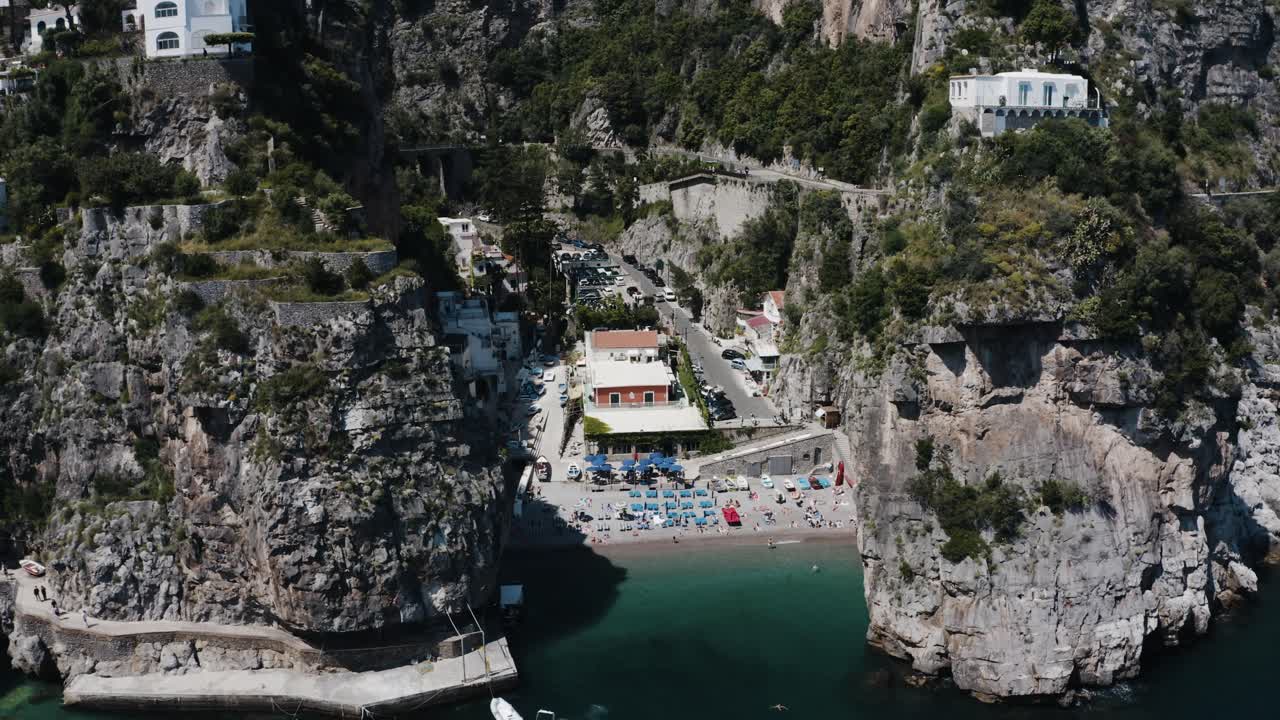 Drone shot pulling away from Praiano's unique waterfront in Italy