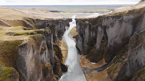 Sharp-cliffs-and-flowing-river-in-Fjadrargljufur-canyon-in-Iceland