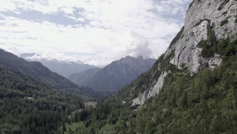 drone video with descriptive frontal shot over the vrsc pass in slovenia with mountains on the horizon