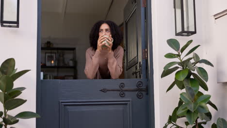 Calm,-cup-of-coffee-and-woman-by-the-door