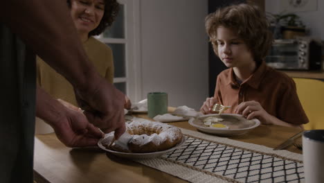 family enjoying cake