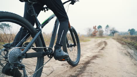 cyclist riding a mountain bike down the road in the countryside