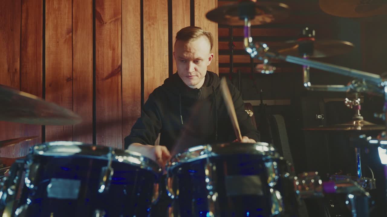 Drummer Playing Drums in a Studio