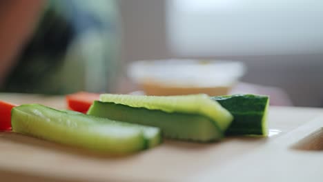Feminine hand moves in slow motion during healthy snack prep, natural lighting