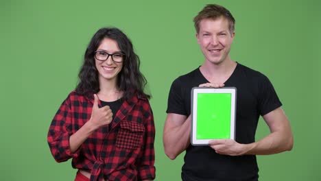 young couple showing digital tablet together