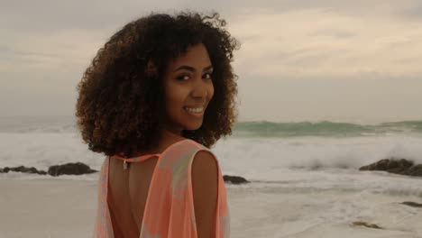 beautiful mixed-race woman smiling on the beach