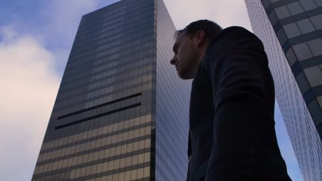 the camera pushes in on a young business man checking his watch in vancouver's downtown core