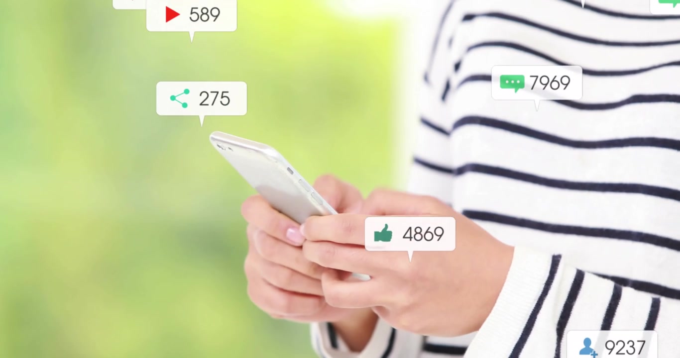 Text and digital icons over man using smartphone against white background