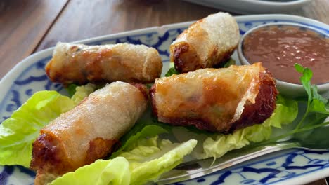 vietnamese fried spring rolls on lettuce leaves and plate