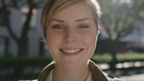 close-up-portrait-of-beautiful-blonde-woman-smiling-happy-enjoying-sunny-city-travel